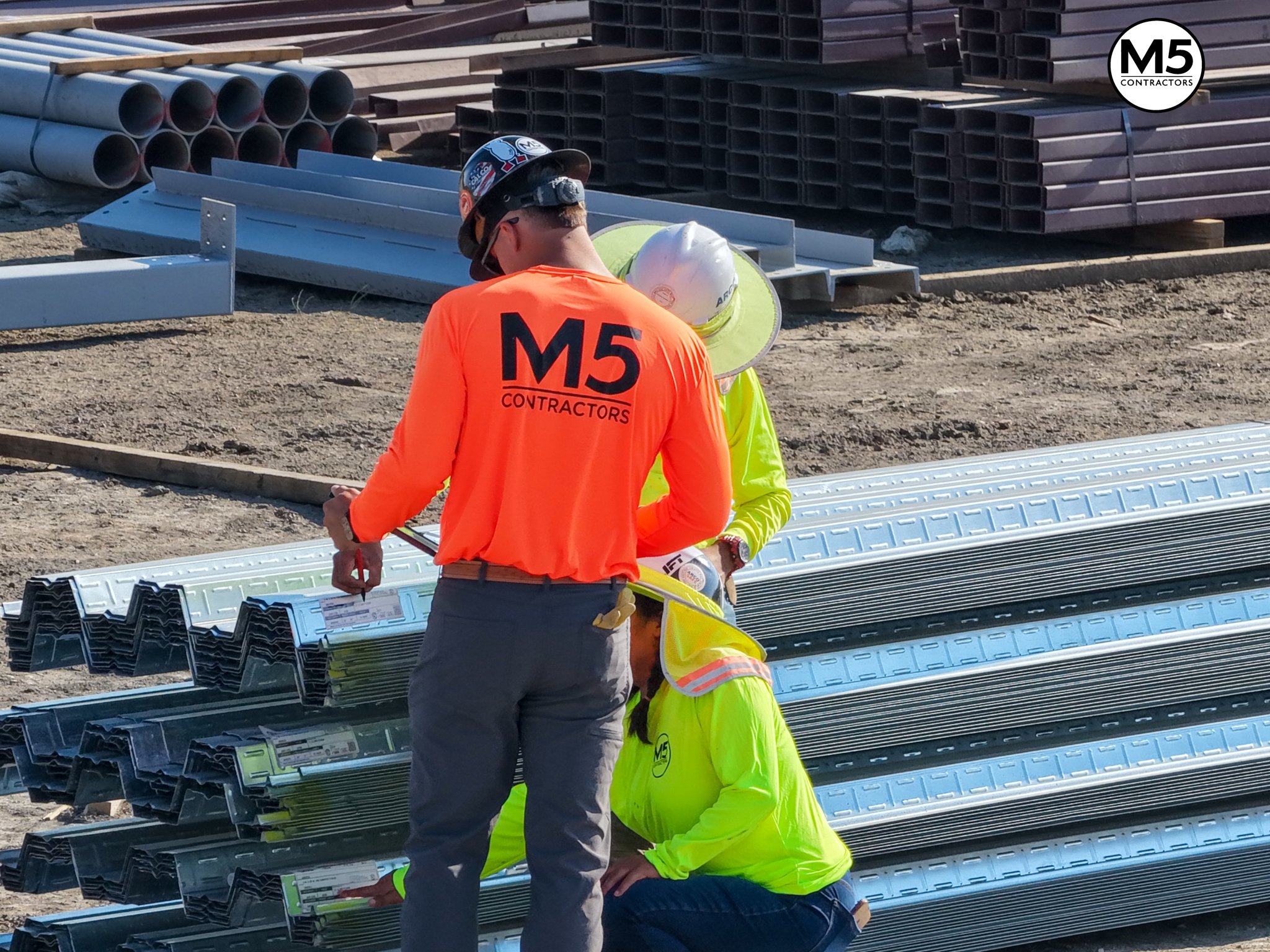 Construction progress drone photo M5 Contractors job site steel delivery