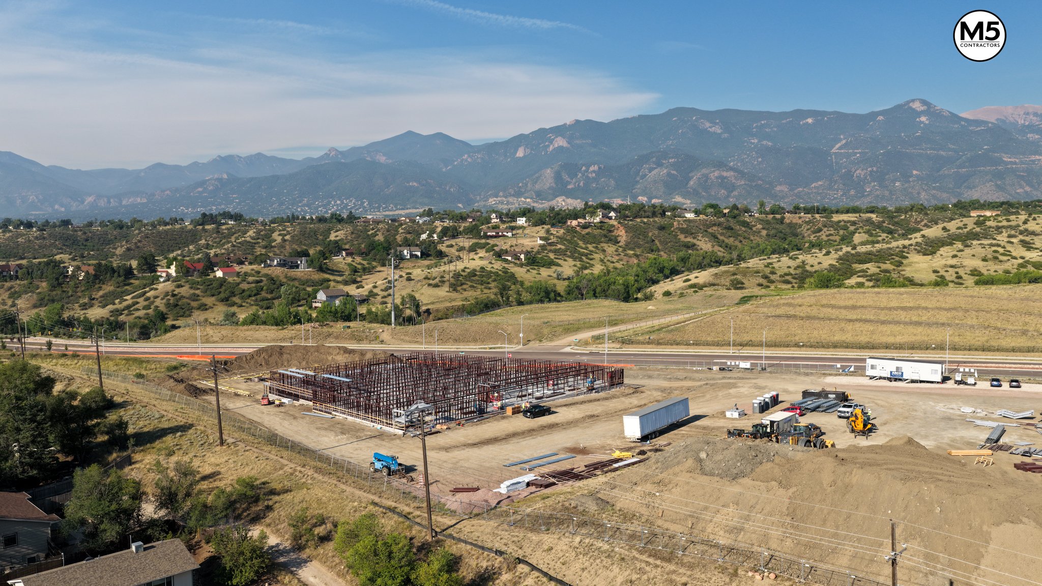 Construction progress drone aerial M5 Contractors commercial site wide view
